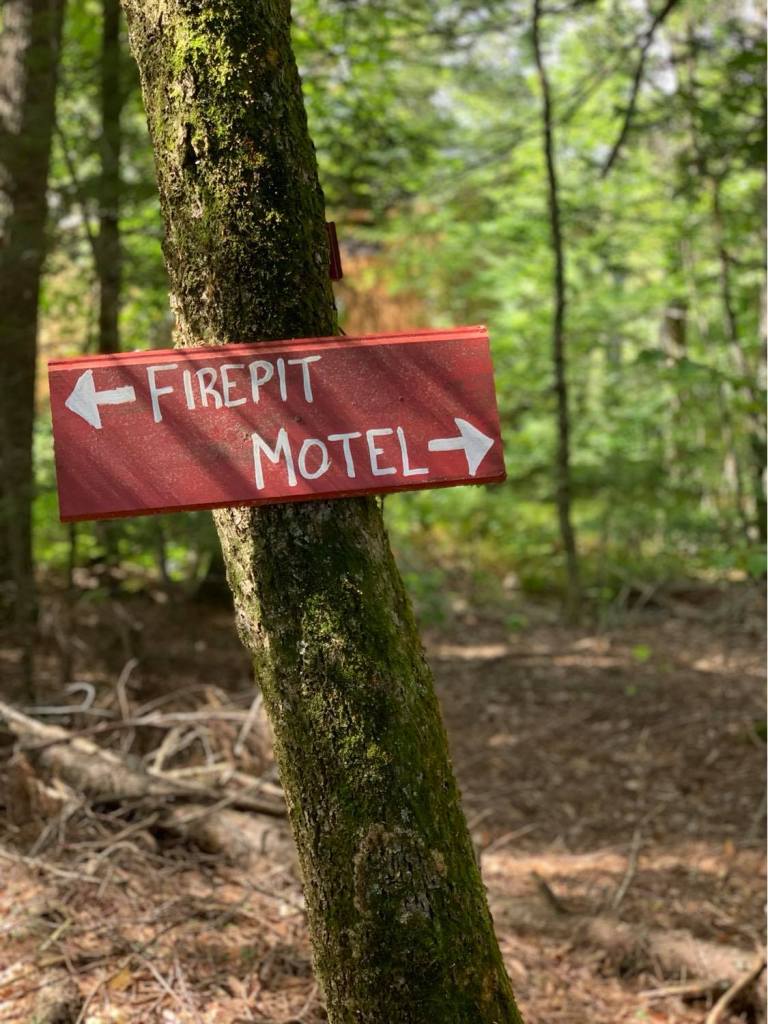 trail sign to fire pit and motel